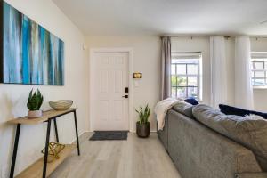 a living room with a couch and a table at Fenced Yard and Hot Tub Pompano Beach Vacation Home in Pompano Beach