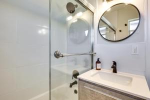 a bathroom with a shower and a sink and a mirror at Fenced Yard and Hot Tub Pompano Beach Vacation Home in Pompano Beach +19 photos