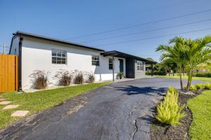 a driveway in front of a house at Fenced Yard and Hot Tub Pompano Beach Vacation Home in Pompano Beach