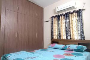 a bedroom with a bed and a dresser at 2 BHK Full Furnished in Kukatpally #101 in Hyderabad