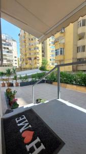a balcony with a rug on the floor of a building at Tranquil Oasis for Two in Tirana