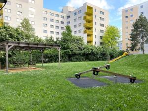 a park with two skateboards and a bench in the grass at Near VIC Austria Center, 90sqm, 3BR, LR, Kitchen, 6min to VIC, 10min to City U1 in Vienna