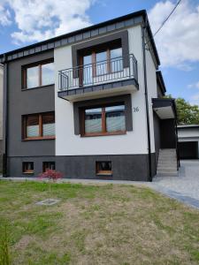 a house with a balcony on the side of it at Apartamenty Wadowity- Energylandia Zator in Wadowice