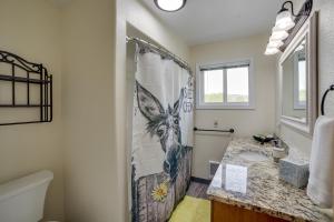 a bathroom with a shower curtain and a sink at Cozy Montana Retreat with Patio, Grill and Fire Pit! in Choteau