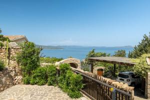 a stairway leading to a house with a view of the water at [VILLETTA VISTA MARE] Cala dei Ginepri con Giardino in Cala Bitta