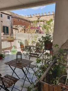 a patio with tables and chairs on a balcony at Stanze al Genio B&B in Palermo