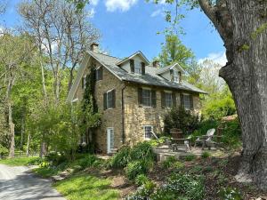 a stone house with a table and chairs in front of it at Goodstone Inn & Restaurant in Middleburg