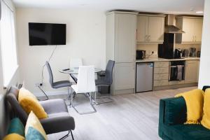 a living room with a table and chairs and a kitchen at Ballycastle 7A Diamond 2 bedroom apartment in Ballycastle
