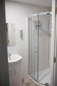 a bathroom with a shower and a sink at Vanity Ballycastle Diamond 2 bedroom apartment in Ballycastle