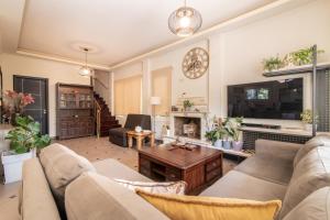 a living room with a couch and a table at Zamor Family Villa 1 in Mouzákion