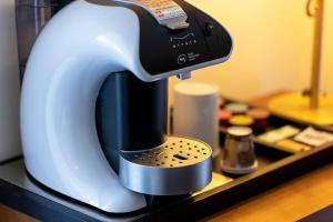 a white and black mixer sitting on a counter at Hotel International in San Benedetto del Tronto