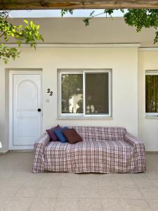 a couch sitting on a patio in front of a door at Sea View Villa in Agia Thekla in Ayia Napa