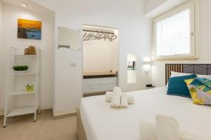 a bedroom with a large white bed and a window at Coral - 30 passi dalla Spiaggia della Purità in Gallipoli