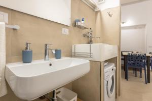 a bathroom with a white sink in a room at Coral - 30 passi dalla Spiaggia della Purità in Gallipoli +33 photos