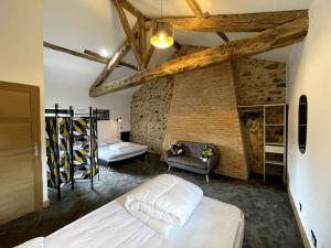 a bedroom with two beds and a couch at Gîte à la campagne au bord d'un Lac 8 personnes in Saint-Quentin-sur-Charente +34 photos