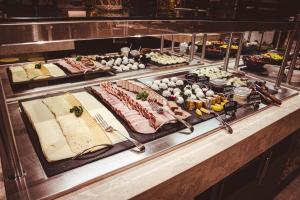 a buffet with many different types of food on display at Holiday Inn Dąbrowa Górnicza-Katowice, an IHG Hotel in Dąbrowa Górnicza