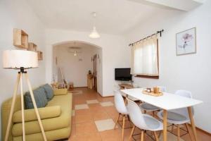 a living room with a couch and a table at Charming villa with private pool near the sea and garden in Ripenda Kras