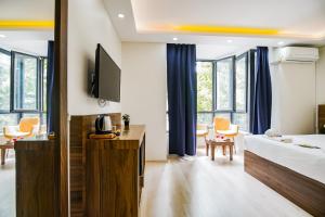 a hotel room with a bed and a tv at MITANI SUITES in Istanbul