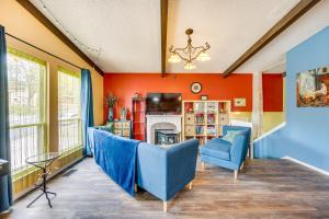 a living room with blue chairs and a fireplace at Colorado Springs Home with Patio and Ping Pong Table! in Colorado Springs