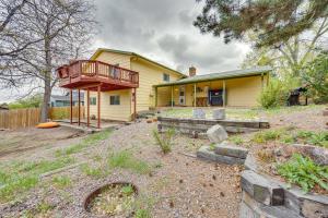 a yellow house with a balcony and a yard at Colorado Springs Home with Patio and Ping Pong Table! in Colorado Springs