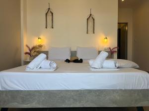 a large white bed with two pillows on it at House Kohili in Nea Vrasna