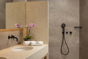 a bathroom with a sink and a shower at Atlantica Bay - Adults Only in Limassol