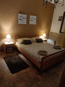 a bedroom with a bed with two tables and two lamps at casa Maria in Palermo