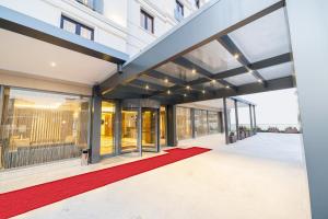 an external view of a building with a red carpet at Lamec Hotel Business in Gebze