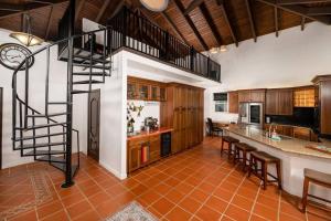 a kitchen with a spiral staircase in a room at Casa Colibri + Casita - Villa w/ocean views in Vieques