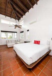 Casa Colibri + Casita - Villa w/ocean views في بييكيس: غرفة نوم مع سرير أبيض كبير في غرفة