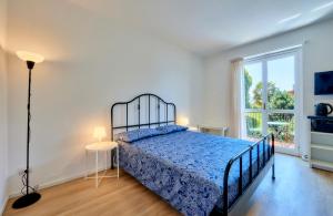 um quarto com uma cama e uma grande janela em Appartamento Pinus Varenna em Varenna