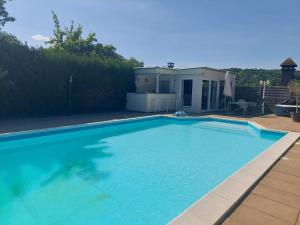 a large blue swimming pool sitting next to a house at Gite Marigot in Bazincourt-sur-Saulx