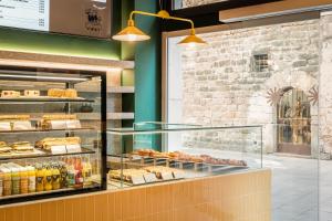 a bakery with a display case filled with pastries at BYPILLOW Twenty in Barcelona