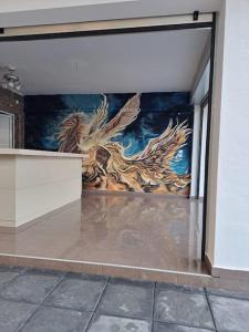 a wall with a dragon mural on it in a building at "BenLin" 3 in Paralia Katerinis