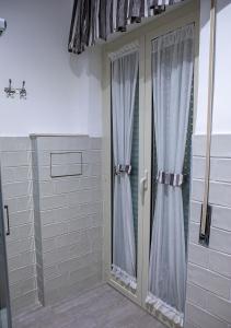 a bathroom with a shower and a glass door at zuroli suite in Naples