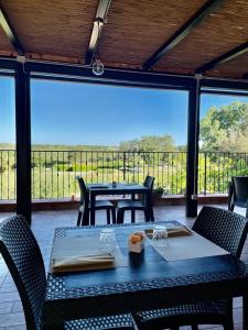 a table and chairs on a patio with a view at Agriturismo I Tre Fossi in Magliano in Toscana