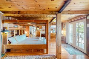 a bedroom with a bed with a wooden ceiling at Belle's Buttercup in Dundee