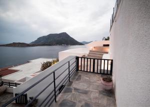 a view of the water from the balcony of a house at Blue Dawn Kalymnos in Kalymnos