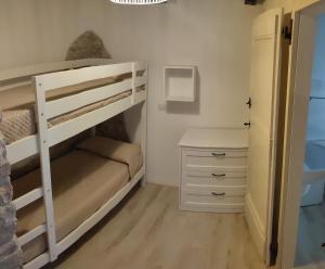 a bedroom with a bunk bed and a desk at APPARTAMENTI VACANZA SAN SILVESTRO in Piobbico