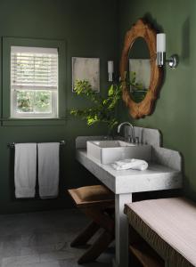 a bathroom with a sink and a mirror at Hidden Pond Resort in Kennebunkport