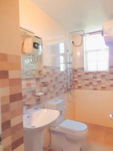 a bathroom with a toilet and a sink at Terrabella - Nuwara Eliya in Nuwara Eliya