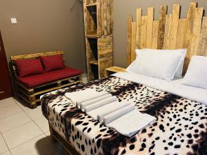 a bedroom with a leopard print bed and a chair at Safari villa in Arusha +147 photos