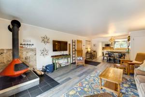 a living room with a fireplace and a couch at Riverfront Condo Near Downtown Estes Park! in Estes Park