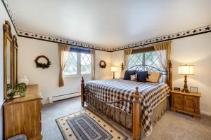 a bedroom with a bed and a window at Riverfront Condo Near Downtown Estes Park! in Estes Park