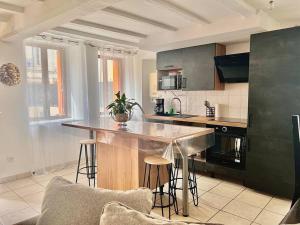 Maison avec terrasse cosy, 2 chambres, wifi, parking في Ruelle-sur-Touvre: مطبخ مع جزيرة في وسط الغرفة