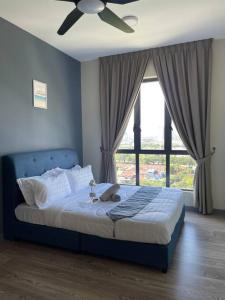 a bedroom with a blue bed with a ceiling fan at 8 Pax Family 100Mbps Kepong DesaPark MontKiara Publika Mitec in Kuala Lumpur