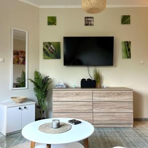 A television and/or entertainment centre at Móló Beach Lelle Apartman Még 4 kép