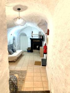 a room with a bed and a piano in a cave at Casa Cueva LA PARRA. in Terque