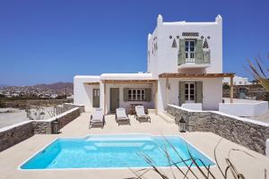 a villa with a swimming pool and a house at Philippi Villa in Mýkonos City