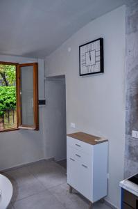 een kamer met een klok op een witte muur bij Appartamento Urbino in Urbino